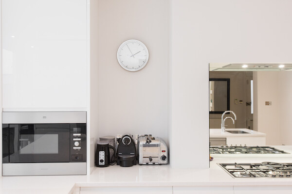 Contemporary kitchen detail with built-in microwave and gas hob