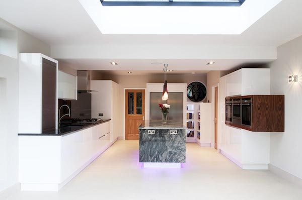 High-gloss white contemporary kitchen with marble island and LED base