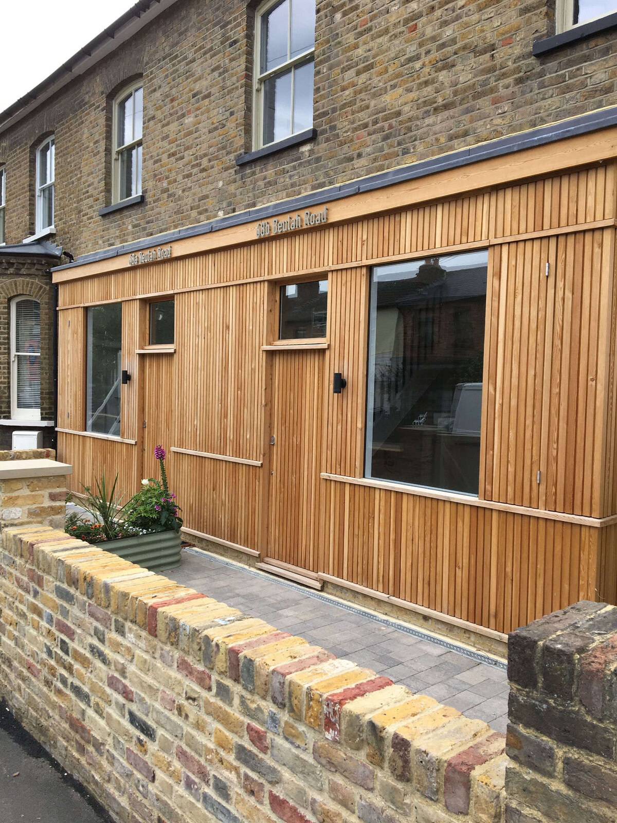 Bespoke cedar-clad timber facade with concealed entrance doors