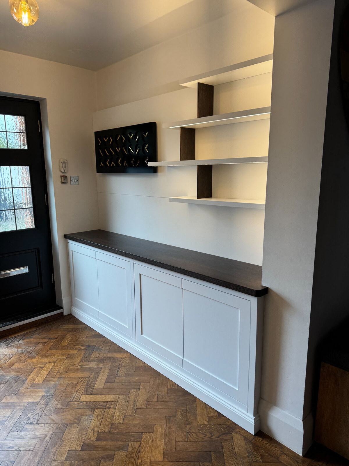 Painted shaker hallway cabinet with floating shelves and dark timber top