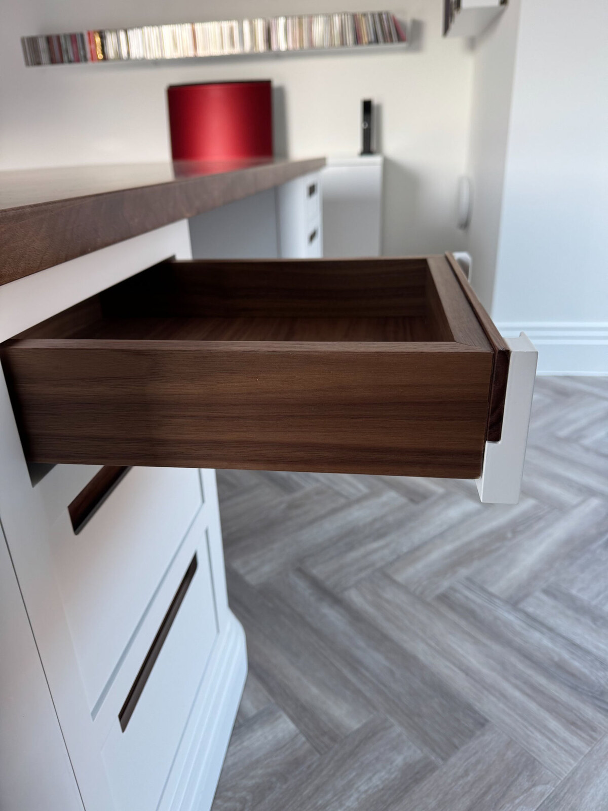 Open desk drawer showing walnut interior