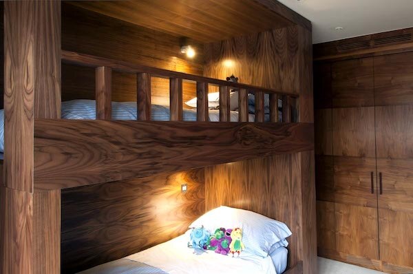 Bespoke solid walnut bunk-bed cabinetry with figured grain